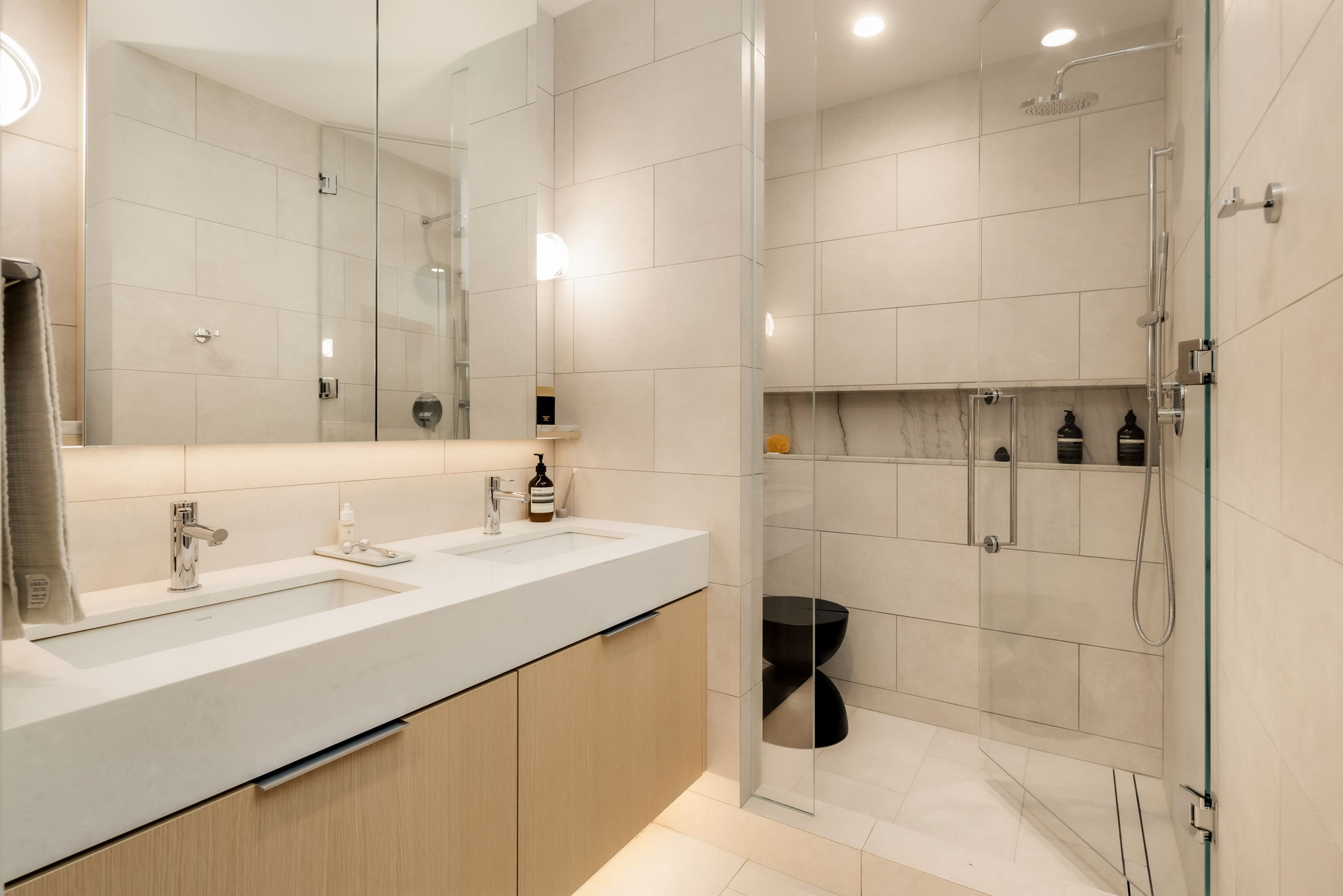 Modern bathroom with walk-in shower and floating vanity in Ashleigh Oakridge Vancouver condo