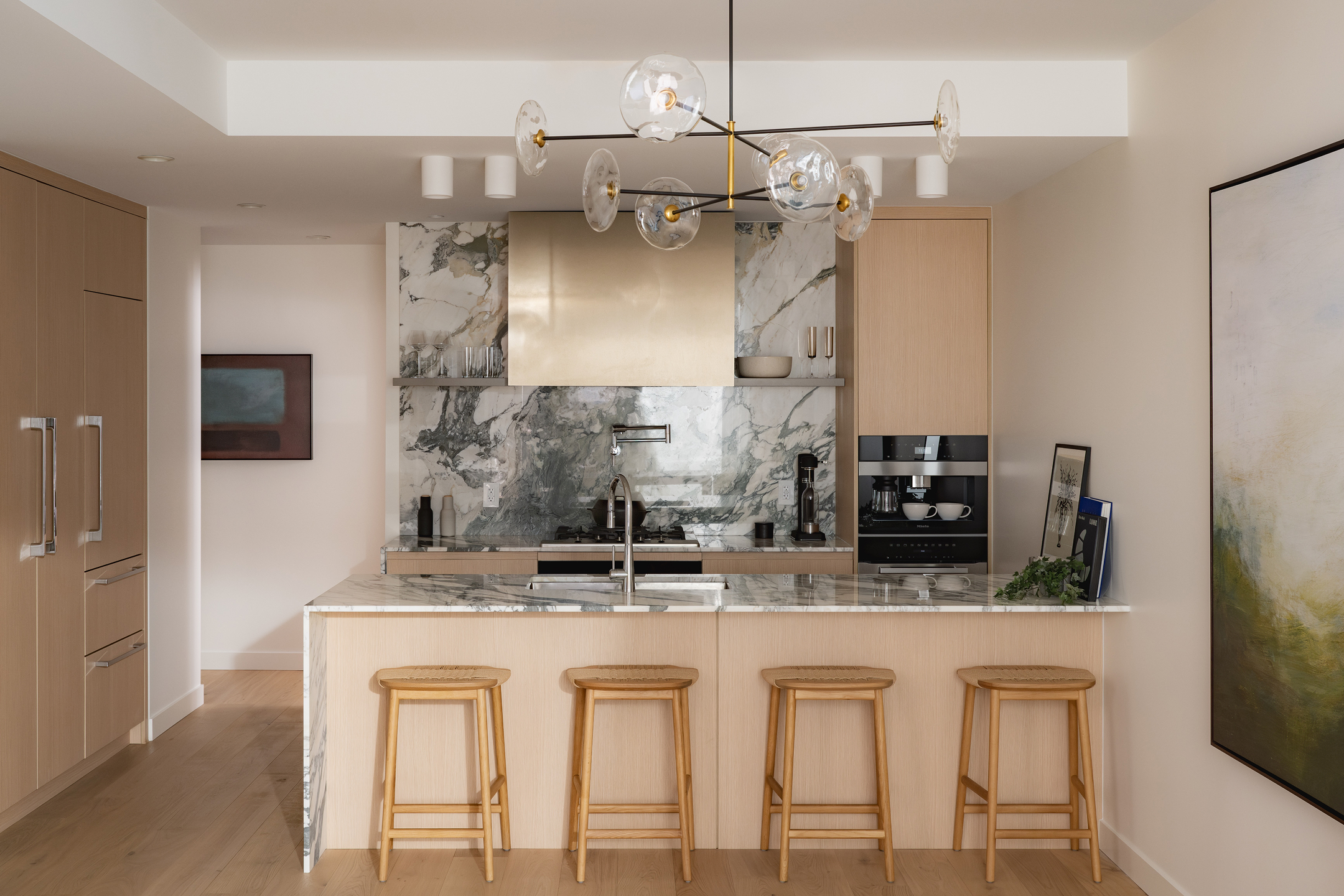 Modern kitchen with island and premium appliances in a boutique concrete condo Ashleigh Oakridge Vancouver