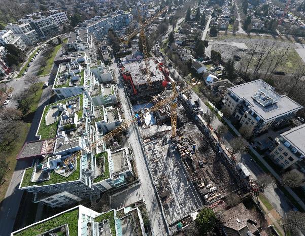 Aerial view of Ashleigh Oakridge construction site with cranes and concrete structure progressing in Vancouver West Side